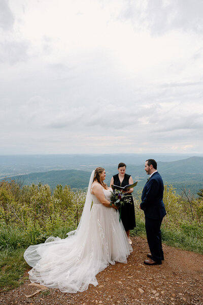 A couple saying their vows at Jewell Hollow in Shenandoah National Park during their elopement with family