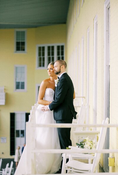 Bride and groom smile on balcony at their Congress Hall Wedding