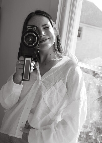 Alexandra Eveland shooting super8 film in a white linen top
