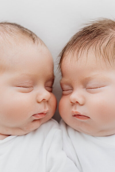 Twin newborn babies, fast asleep on their newborn photoshoot in Cheshire