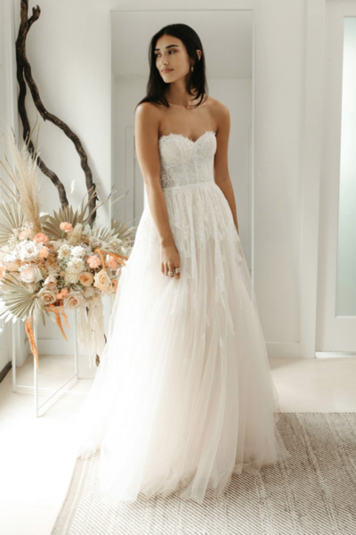 Sweetheart ball gown with feather motif lace placed on bodice and strategically trickling down the skirt from the waistline, scattered clear sequins, and finished off at the waist with a velvet ribbon.