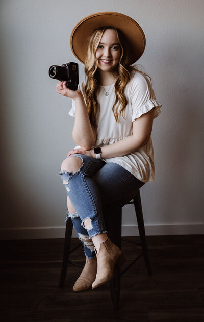 ChloeParkerPhotography Maddie Sitting on a stool with camera in hand