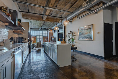 Kitchen  with open concept layout, open beam ceilings, and modern feel in this vacation rental condo in downtown Waco, TX