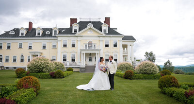 Bride and Groom pose in front of Vermont Inn