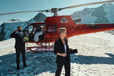 wedding officiant standing in front of helicopter in whistler