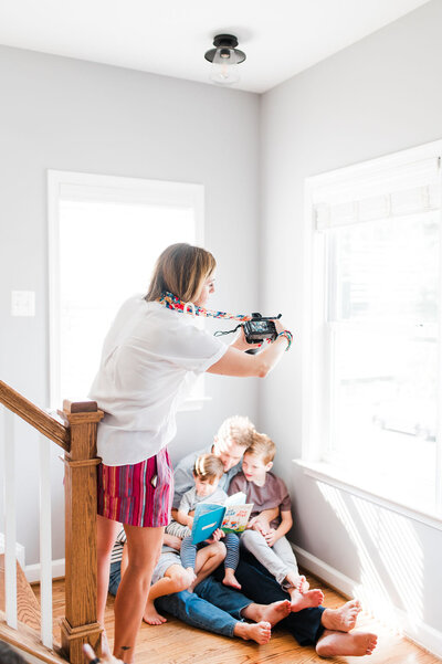 photographer taking a photo at an in home family session