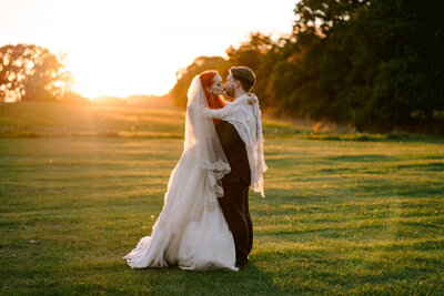 bride and groom kissing on their wedding day at allerton castle in yorkshire