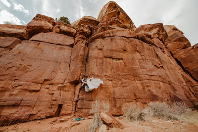 bride and groom rock climbing in Kanab Utah