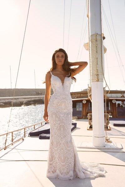 Far away from land and water bound, Marley is the goddess of sun and sea. Leave lavish gowns behind as Madi Lane brings you drama-free Marley. She is for the bride who is looking for a fiercely feminine silhouette which has a casual air about her. She is ideal for the laid back bride, which is reflected in her easy going design which comes in both ivory and warm mocha undertones. Her no fuss attitude is seen through her artesian spaghetti straps making her shoulders bare to the sun, her neckline dips before coming to a halt at her bodice and her back is humbly lowered and open. Marley’s main feature is the exquisite scallop lace which keeps with her marine ideals. Fine prickled scalloping outlines her neckline and then enlarges as it makes its ways down to the hem before gently fluting into a minimal train. Marley’s modern bride look simulates a low-key celebration or elopement, allowing her bride to really get down and enjoy her special day.