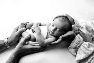 newborn baby held by parents hands, by nj newborn photographer