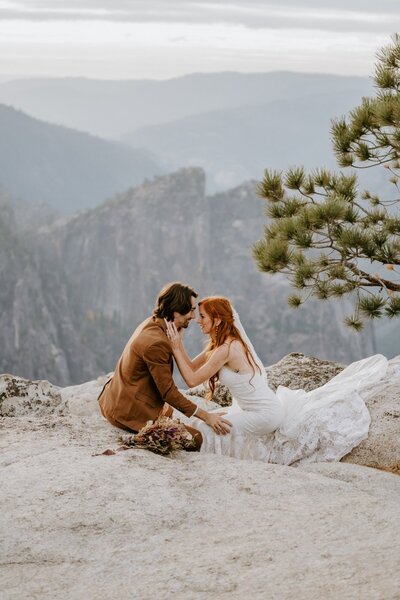 bride and groom kissing on mountain