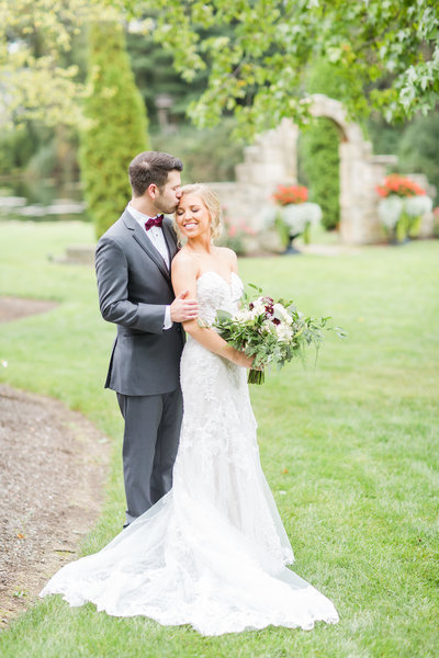 textured wedding bouquet with greens, whites, and purples at oaks lakeside wedding