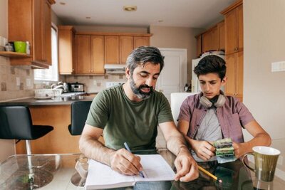 parent helping teen with homework