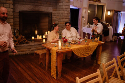 Couple sitting at sweetheart table at wedding reception - UME (New England Wedding planners were wedding vendors)