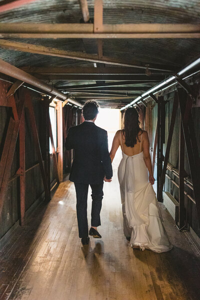 Couple walking holding hands on wedding day, Unique Melody Events & Designs helped with weddy