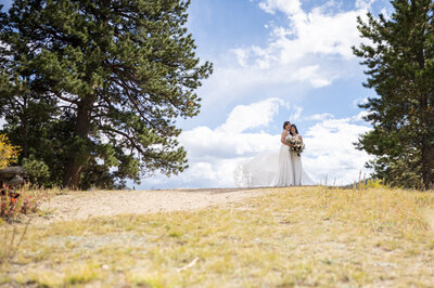 Couple kissing at top of horsetooth for their portraits before the reception