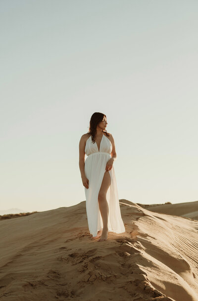 Portrait of a woman on sand dunes in albuquerque new mexico.