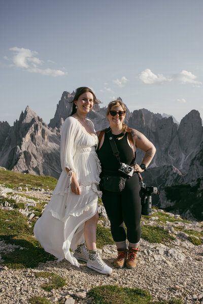 Italy elopement photographer poses with bride in the dolomites