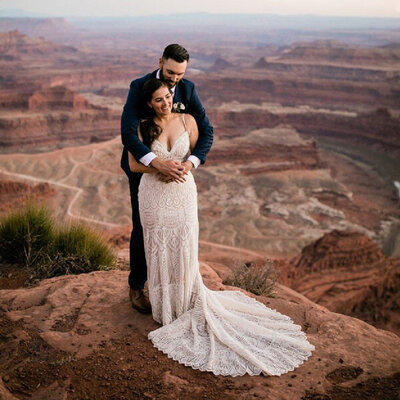 Couple embrace on a cliff