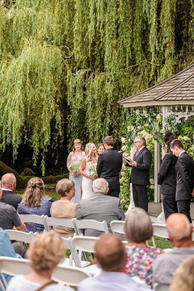 Garden wedding ceremony by willow tree