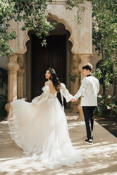 bride and groom walking on a path