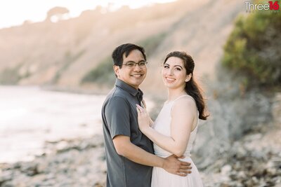 Engaged couple share a romantic kiss overlooking the ocean at the Abalone Cove Shoreline Park
