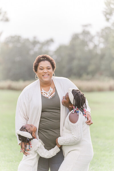 daughters looking at mom during their fall mini session in Gainesville, Virginia