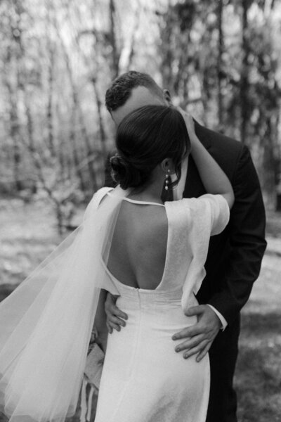 photo of bride and groom embracing taken by City Hall wedding photographer San Francisco