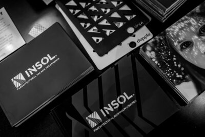 Black and White close up image of brochures for Insol Architectural Facade Treatment and Design captured by Zanthe Vorsatz Photography - Auckland Event Photographer