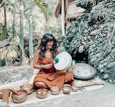 Alex Shambori leading a cacao ceremony and DJ session in Puerto Escondido, blending yoga, tribal rhythms, and holistic fashion in a vibrant community gathering.