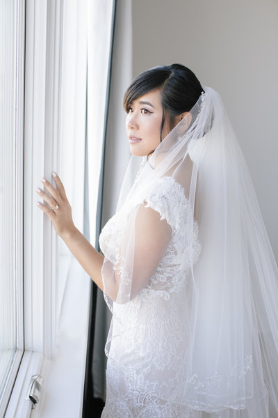 bride starring out window before wedding