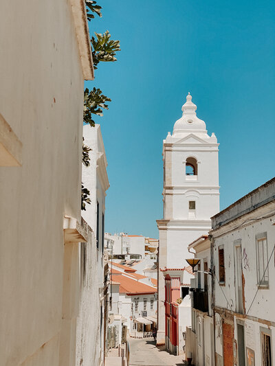 teh serene white buildings of Old Town Lagos, Portugal during the middle of the day. Any time of day makes for beautiful photos in this charming town.