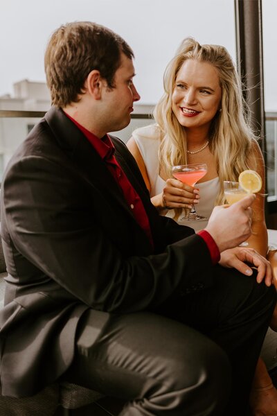 Couple enjoys drinks together during their couples photos session.