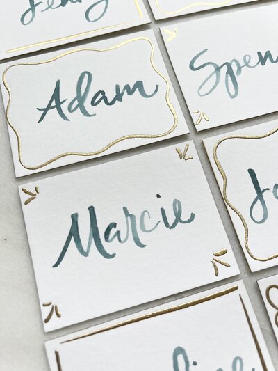 Place cards with blue watercolor calligraphy