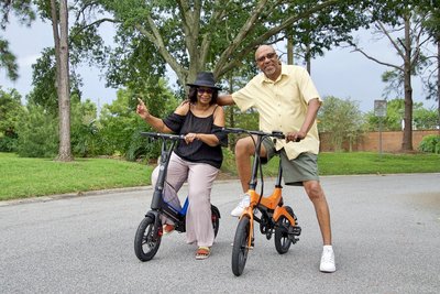 Married couple enjoying a scenic ride on there Blue Go-Bike M3 and Orange Go-Bike M4