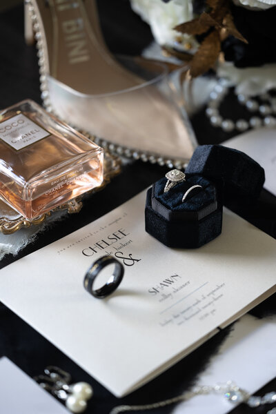 wedding rings, stationery, a perfume bottle, and bridal shoes