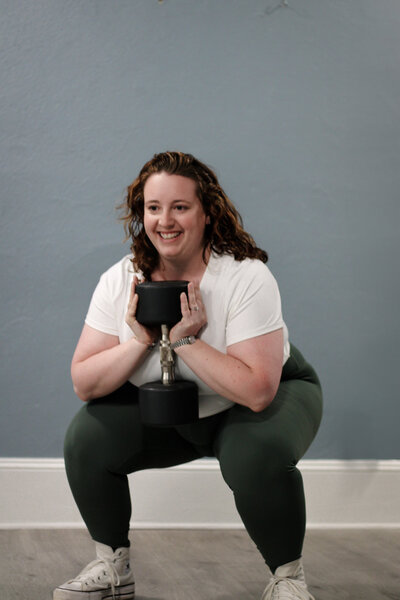Client smiling during a strength class at TruFit Pilates studio