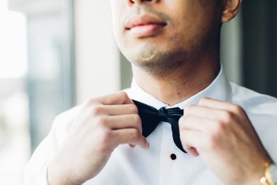 Baltimore Groom tying bow tie