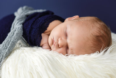 Beautiful Mississippi Newborn Photography: newborn boy wrapped in navy and gray