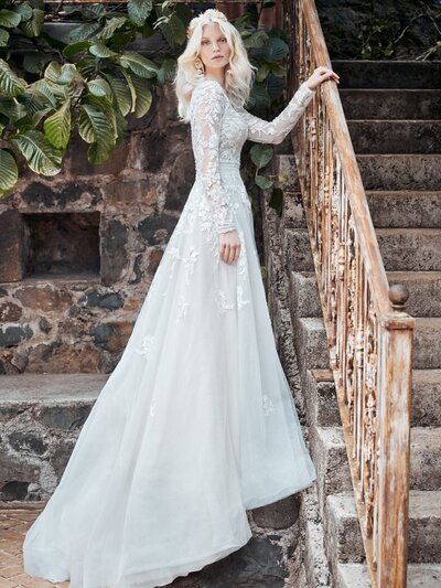 Boho Tulle A-line Wedding Dress. A portrait of a lady-a bride who knows what she likes, at the height of her style game, wearing a boho tulle A-line wedding gown inspired by big bouquets and summer celebrations.