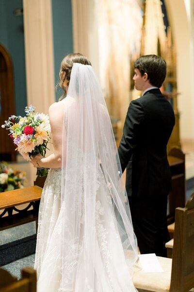 Bride and Groom standing side by side at wedding ceremony