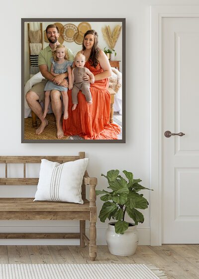 A family of four smile dressed  in boho orange and green