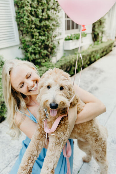 South Florida wedding photographer hugging her golden doodle dog