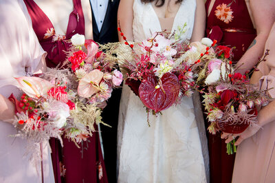 Wedding party holds bohemian wedding bouquets