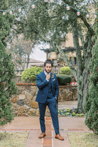 groom posing outdoors