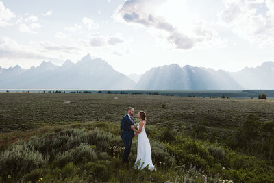 A couple having their first dance at Schwabacher Landing in Grand Teton National Park