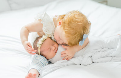 San Diego Newborn Photography, sisters holding new baby