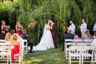 garden ceremony kissing under willow tree
