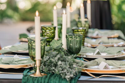A green tablescape of vintage cups and plates by JoLynn Photography