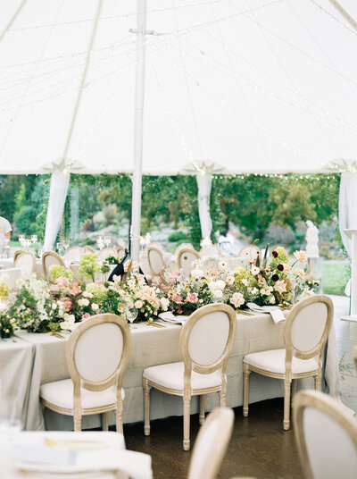 chairs and florals under tidewater tent